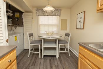 A small kitchen with a table and chairs.at Chapel Valley Townhomes, Maryland, 21236